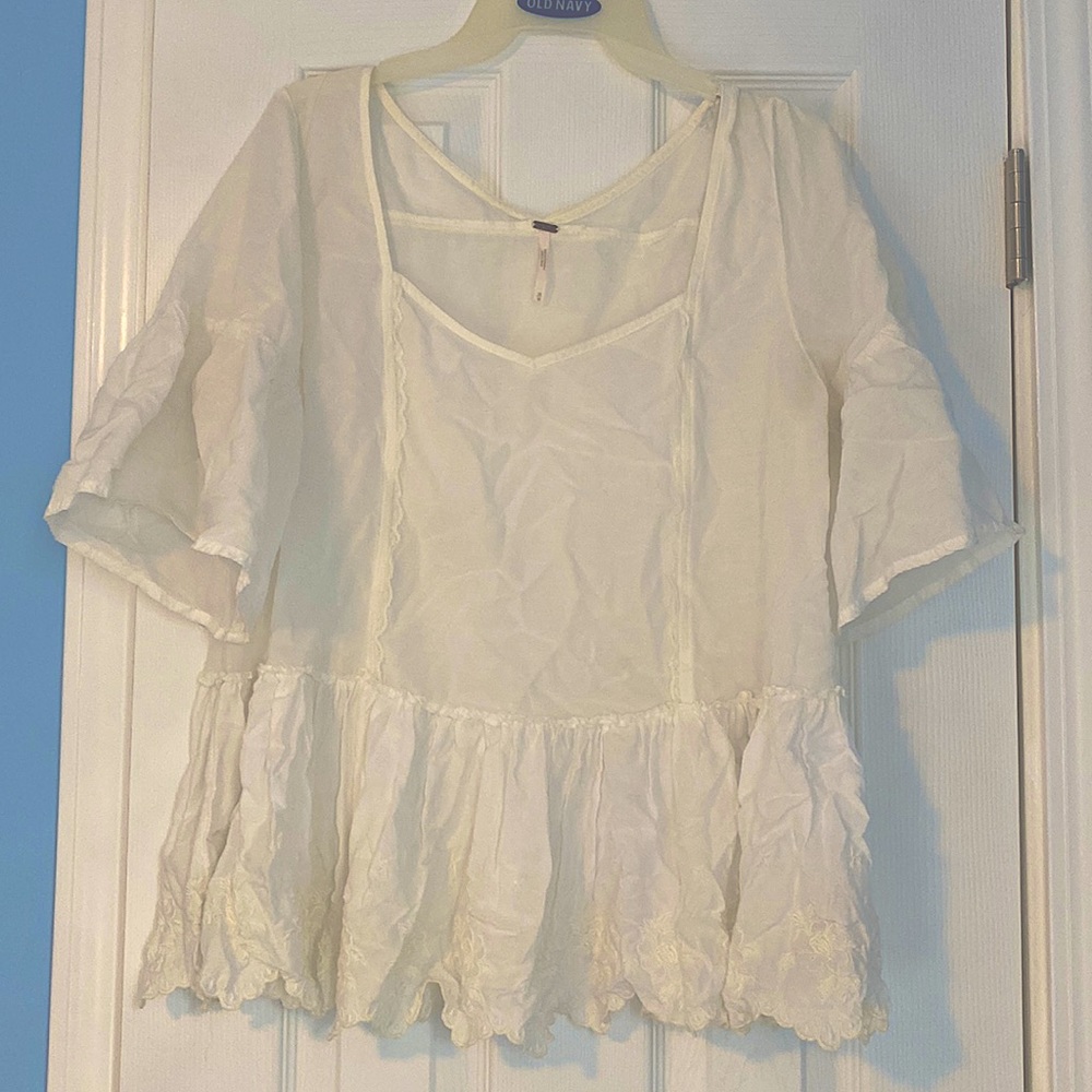 Free people white blouse with lace detailing on the bottom